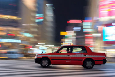 Blurred motion of car on illuminated city street