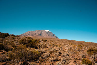 Scenic view of mountains against clear blue sky