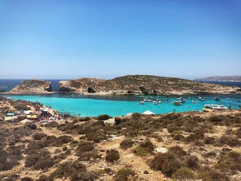 Scenic view of sea against clear blue sky