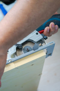 Close-up of person working on metal