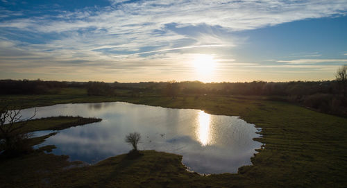 Scenic view of lake against sky during sunset