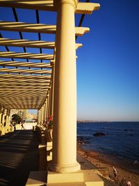 View of beach against clear blue sky