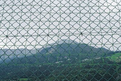 Full frame shot of chainlink fence against sky