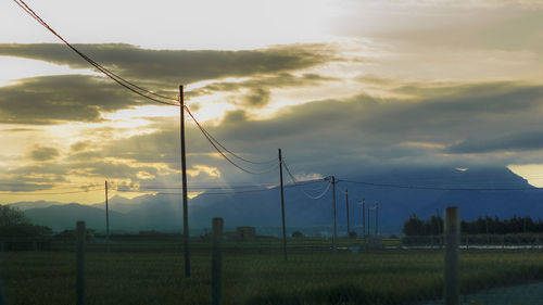 Scenic view of field against cloudy sky