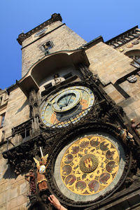 Low angle view of clock tower against building