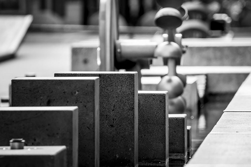 indoors, focus on foreground, selective focus, metal, close-up, table, still life, metallic, in a row, wood - material, no people, day, communication, wooden, text, chair, western script, large group of objects, railing, empty