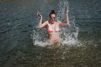 Cheerful woman enjoying in lake