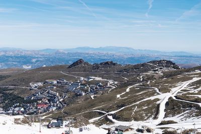 High angle view of snowcapped mountains against sky