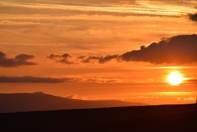 Scenic view of dramatic sky during sunset