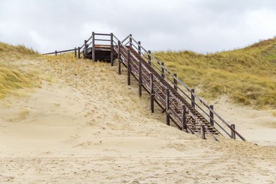 Built structure on beach against sky