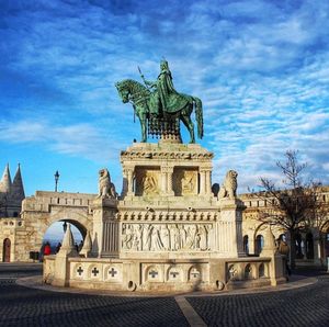 Low angle view of statue against cloudy sky