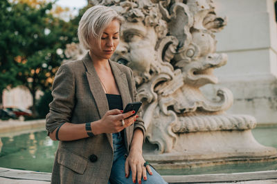 Full length of man using mobile phone