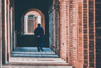 Rear view of man walking on steps