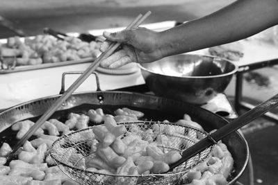 Close-up of man preparing food in kitchen