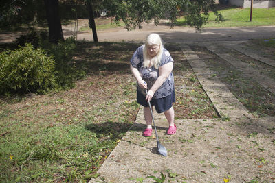 Full length of woman standing on footpath