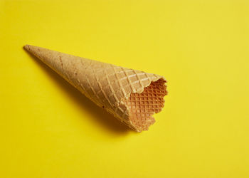 High angle view of bread on yellow background