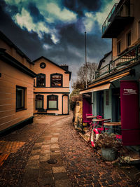 Houses by street in town against sky