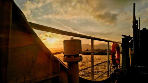 Bridge over sea against sky during sunset