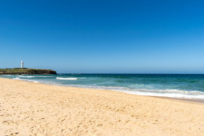 View of beach against blue sky