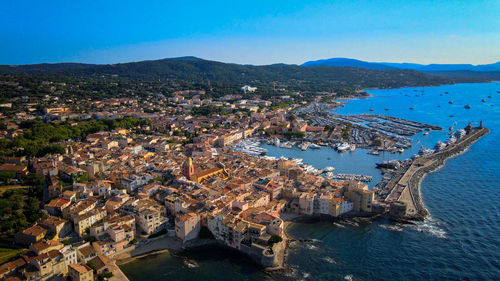 High angle view of townscape by sea against sky