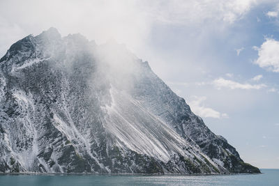 Aerial view of sea and mountains against sky