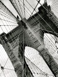Low angle view of suspension bridge against sky