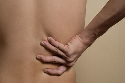 Close-up of hands against gray background