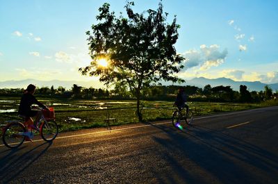 People on road at sunset