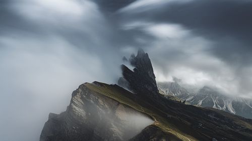 Scenic view of mountains against cloudy sky