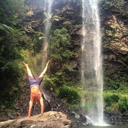 Full length of man on waterfall against sky