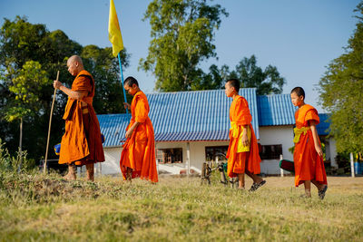 People on field against clear sky