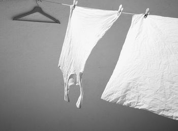 Low section of woman hanging on bed against white background