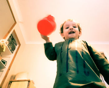 Low angle view of girl holding balloons