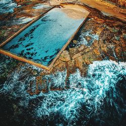 High angle view of swimming pool by sea