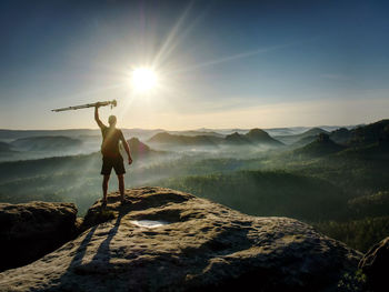 Man standing on mountain against sky