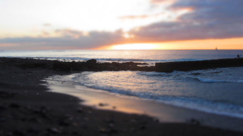 Scenic view of beach at sunset