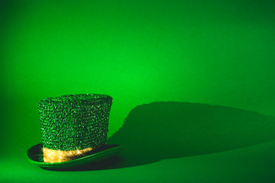 Close-up of crystal ball on table against green background