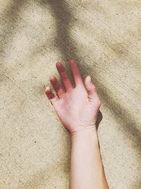 Low section of woman on sand