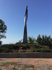 Low angle view of cross against clear blue sky