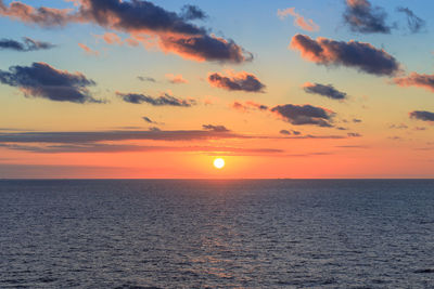 Scenic view of sea against romantic sky at sunset