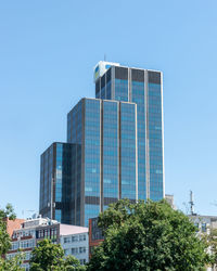 Low angle view of modern building against clear blue sky