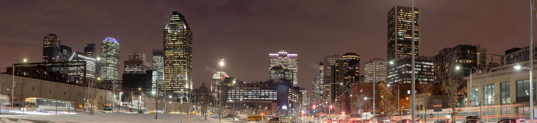 Panoramic view of city lit up at night