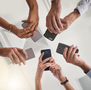 Cropped hands of man using mobile phone