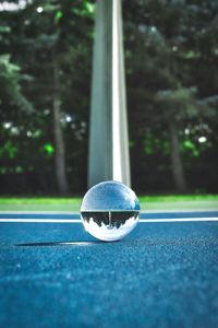 Close-up of crystal ball on blue land