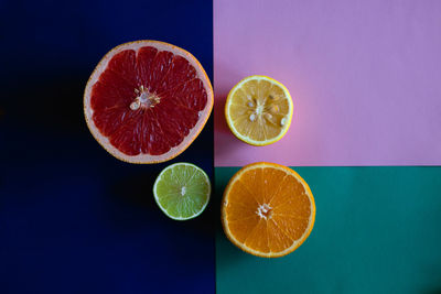 Close-up of oranges on table against gray background