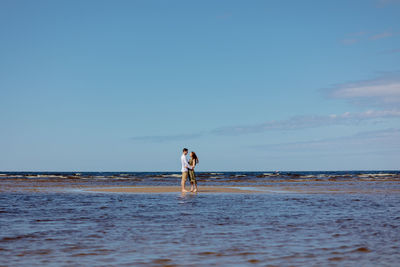 Couple of a man and a woman on a date on the beach by the sea.  walk picnic of two lovers in nature