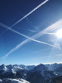 Aerial view of snowcapped mountains against clear blue sky