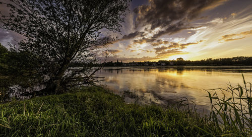 Scenic view of lake against sky during sunset