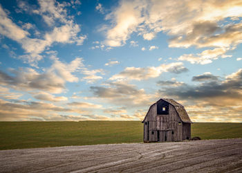 Scenic view of field against cloudy sky