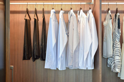 Clothes hanging in cabinet at home